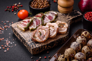 Raw quail eggs in a plastic box on a dark concrete background