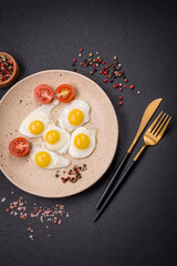 Delicious nutritious breakfast of fried quail eggs, bacon, legumes and cherry tomatoes