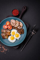 Delicious nutritious breakfast of fried quail eggs, bacon, legumes and cherry tomatoes