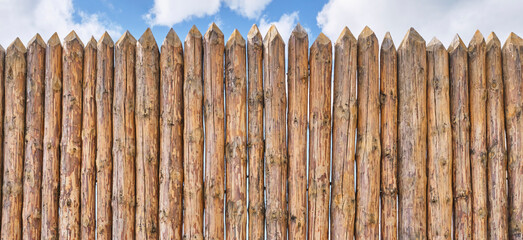 Palisade and a little of cloudy sky as abstract rustic or historical background.