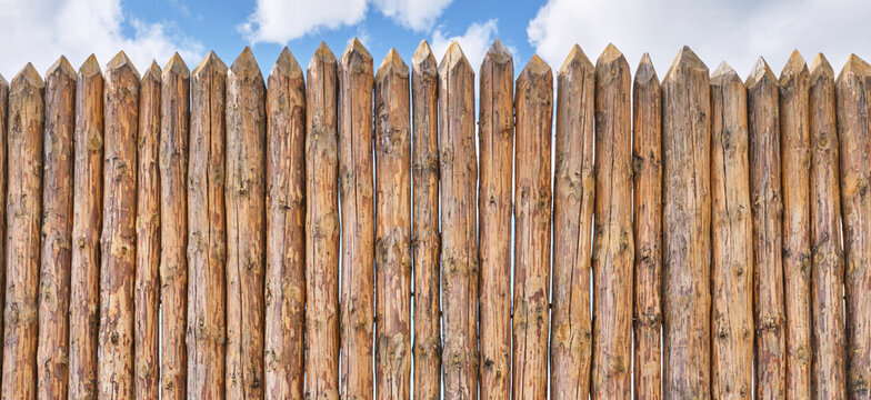 Palisade and a little of cloudy sky as abstract rustic or historical background.