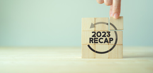 2023 Recap economy, business, financial concept. For business planning. RECAP word icon on wooden...