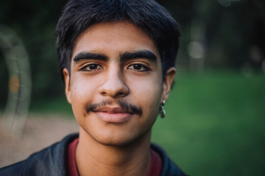 Portrait of smiling teenage boy with mustache