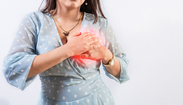 Unrecognizable woman with chest pain isolated. Girl with heart pain on isolated background. Concept of people with heart problems