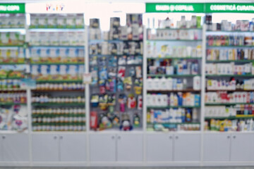 Blurred view of pharmacy stocked shelves. Healthcare and cosmetics industry defocused background
