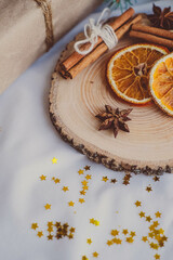 Christmas decoration with dried orange slices, cinnamon sticks and star anise on wooden plate