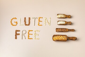 Gluten free text and wooden spoons of various gluten free grains. Flat lay, top