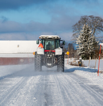 Tractor driving on snowy road Kumla Sweden