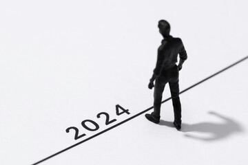 2024 year Business plan concept. Human Figurine on start line looking to the future