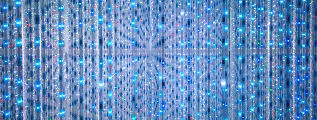Blue and turquoise background of LED flashing, blinking and flickering bulbs. Illuminated backdrop