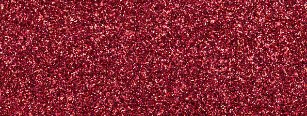 Dark red sparkling background from small sequins, macro. Wine shiny backdrop with glitter pattern