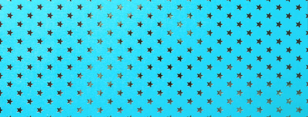 Light blue background from metal foil paper with pattern of silver stars. Texture of cerulean...
