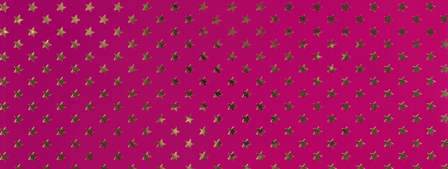 Dark purple background from metal foil paper with pattern of golden stars. Texture of wine wrapping...