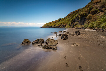 The black volcanic sand beach of Cannitello in Vulcano island, Aeolian islands archipelago IT - 686585545