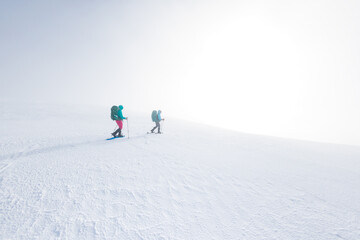 climbers climb the mountain in the snow. Winter mountaineering. two girls in snowshoes walk through the snow. mountaineering equipment. hiking in the mountains in winter.