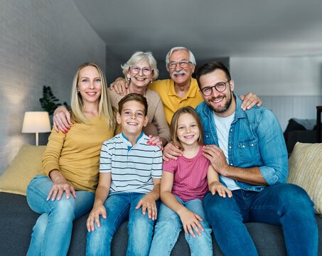 child family portrait woman mother man father grandmother daughter group smiling happy adult girl grandparent generation female grandchild together senior grandfather son boy three