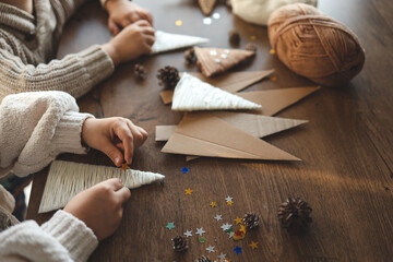 Fototapeta na wymiar Children making Christmas decorations from yarn