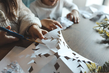 Children cut out snowflakes, Christmas activity