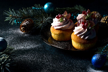 Traditional Christmas cottage cheese cupcakes. Decorated with fir branches and Christmas decorations. Copy space. Low key