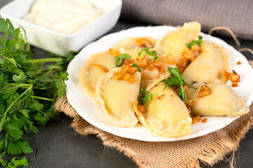 Plate with pierogi filled with sauerkraut and mushrooms