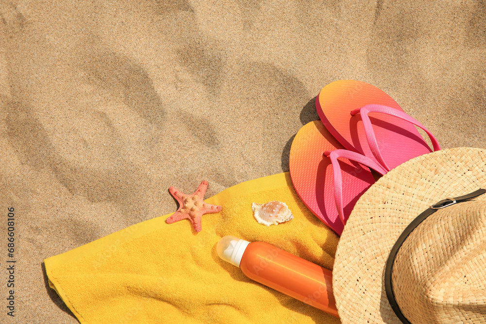 Canvas Prints Straw hat, flip flops and other beach items on sand, flat lay. Space for text