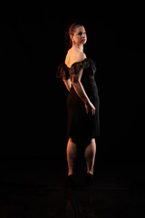 Obraz premium brunette woman posing in black studio