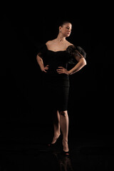 Fototapeta na wymiar brunette woman posing in black studio