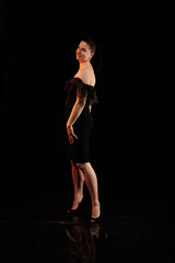 Fototapeta premium brunette woman posing in black studio