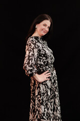 brunette woman posing in black studio