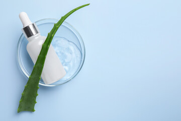 Petri dish with cosmetic products and aloe vera leaf on light blue background, top view. Space for text