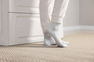 Woman in stylish white socks indoors, closeup
