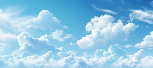 Vibrant and captivating blue sky background with fluffy white clouds on a perfect sunny day