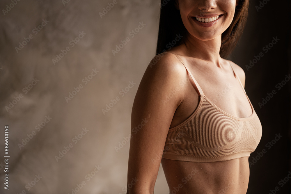 Poster profile side photo of gorgeous sporty sexual woman dressed brassier posing in studio empty space iso