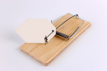 A mousetrap with a tag in the form of a sheet of paper for writing text. A graphic resource on the...