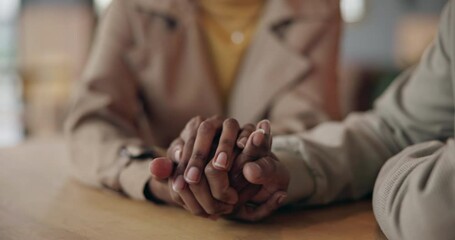 Holding hands, comfort and couple at table for love, trust and care together after cancer diagnosis. Closeup, man support woman and empathy, help in crisis and kindness, connection and hope for faith