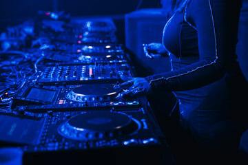 Close up view of a female dj with fresh nails mixing at a music festival