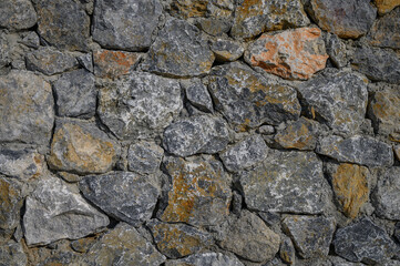 fence made of real stone in large pieces as a background 1