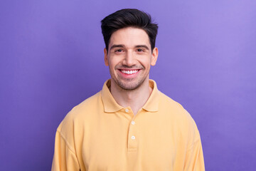 Photo of funny good mood guy wear yellow polo smiling showing white teeth isolated violet color background