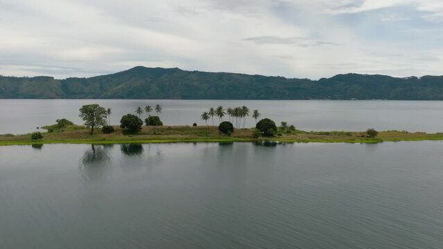 Aerial view of lake Toba is a large natural lake and and an island with palm trees. Samosir, Pulau Toba. Sumatra, Indonesia.