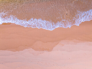 Aerial view of sea crashing waves White foaming waves on beach sand,Top view beach sea surface, Nature sea beach sand background