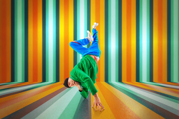 Young sportive man, dude wearing stylishly sport style cloth dancing breakdance elements, freezes...