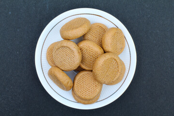 Indian sweet peda or Pera in a plate on black background top view 