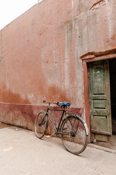 old bicycle leaning against a wall