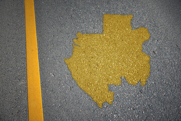 yellow map of gabon country on asphalt road near yellow line.