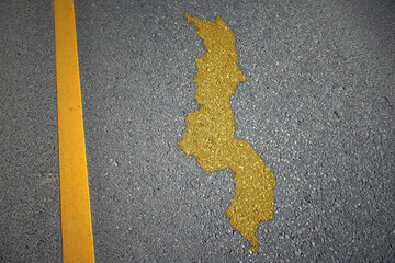 yellow map of malawi country on asphalt road near yellow line.