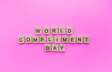 March 1, World compliment day, a minimalistic banner with an inscription in wooden letters
