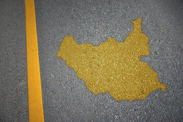 yellow map of south sudan country on asphalt road near yellow line.
