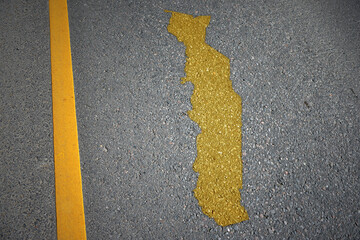 yellow map of togo country on asphalt road near yellow line.