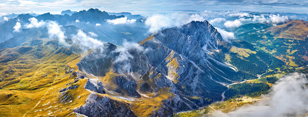 Aerial, High altitude view of panoramic Dolomite peaks around Furcela de Pütia in Passo delle Erbe pass, hiking paths, vivid autumn, sunny day. Dolomites, Italy. 