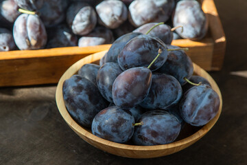 Plum variety Hungarian. Fruit harvest on the table in the kitchen. Autumn blue plum. Vitamin food...